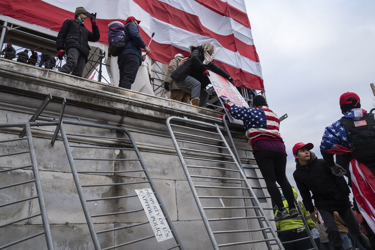Trump supporters climb barricades as part of the mob that attacked the U.S. Capitol on Jan. 6, 2021. MUST CREDIT: Washington Post photo by Michael Robinson Chavez.  (Michael Robinson Chavez/The Washington Post)