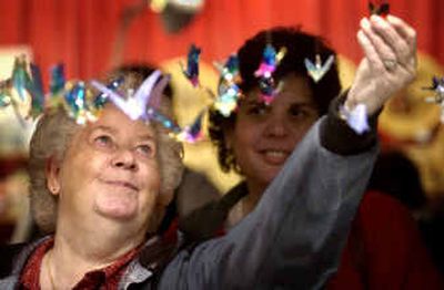 Dalpha Hoggatt, left, looks at glass sculpture ornaments with her daughter-in-law Becky Hoggatt in the Fantasies in Glass booth during the Christmas Memories craft fair. 
 (Holly Pickett / The Spokesman-Review)