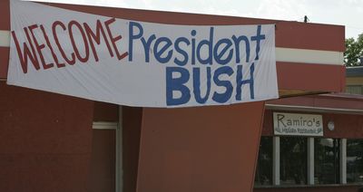 A sign hangs at a restaurant in Woodward, Okla., on Wednesday, welcoming former President George W. Bush, who is scheduled to visit on July Fourth.  (Associated Press / The Spokesman-Review)