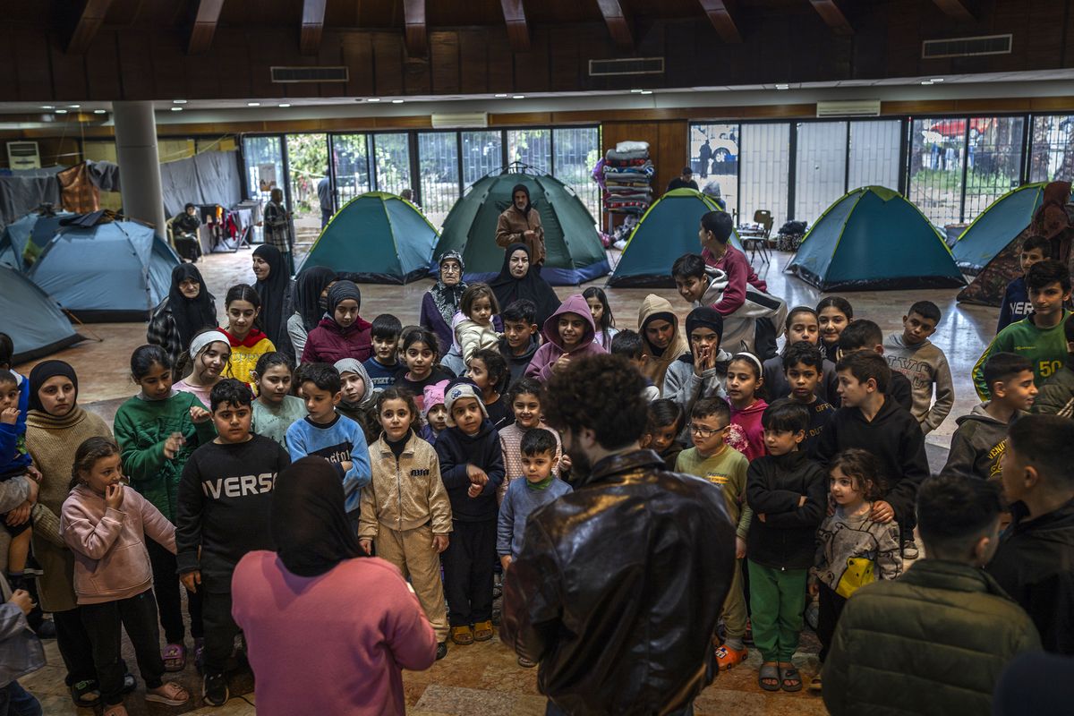 Children gather for a show inside a hotel being used as a shelter in Beirut, March 21, 2026. Israeli forces bombarded the southern suburbs of Beirut before dawn on Saturday, part of a wide-scale campaign against the Iran-backed armed group Hezbollah. (Diego Ibarra Sánchez/The New York Times)  (DIEGO IBARRA SÁNCHEZ)