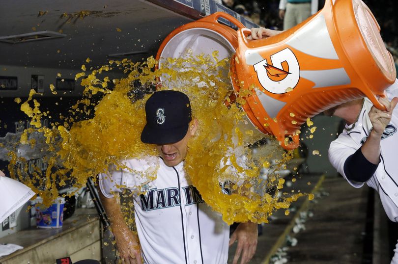 Seattle Mariners lefty Mike Montgomery is showered in sports drinks after his four-hit, 10-strikeout, 105-pitch complete game on Tuesday. (Associated Press)