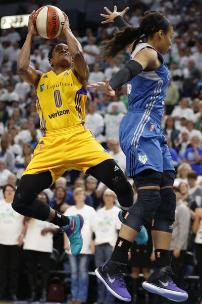 Sparks guard Alana Beard shoots against Minnesota’s Maya Moore. (Stacy Bengs / Associated Press)