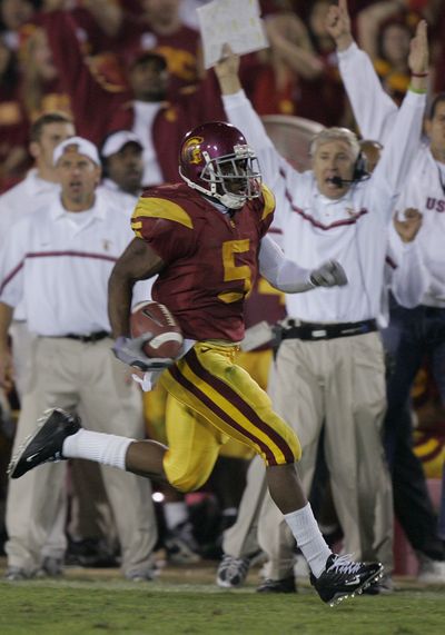 Pete Carroll, background right, had plenty to cheer about while coaching Reggie Bush at Southern California.  (Associated Press)