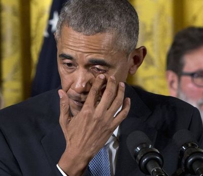 President Barack Obama wipes tears from his eyes as he speaks in the East Room of the White House in Washington, Tuesday, about steps his administration is taking to reduce gun violence. Also on stage are stakeholders, and individuals whose lives have been impacted by the gun violence. (AP Photo/Carolyn Kaster)