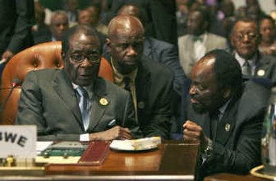 Zimbabwe President Robert Mugabe, left, talks with an aide at the African Union summit in Sharm el-Sheikh, Egypt, on Monday. Associated Press
 (Associated Press / The Spokesman-Review)