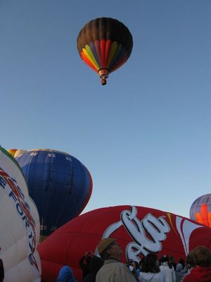 One hot-air balloon lifts off as others inflate at Ann Morrison Park in Boise, as part of the Spirit of Boise Balloon Classic. (Betsy Russell)