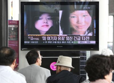 South Koreans watch a news broadcast about two American journalists detained in North Korea at the Seoul Railway Station on Monday. North Korea’s top court convicted the journalists and sentenced them to 12 years in a prison Monday, intensifying the reclusive nation’s confrontation with the United States. The headline reads, “American journalists were found guilty.”  (Associated Press / The Spokesman-Review)