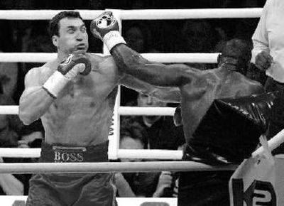 
Wladimir Klitschko, left, and Ray Austin exchange punches. 
 (Associated Press / The Spokesman-Review)