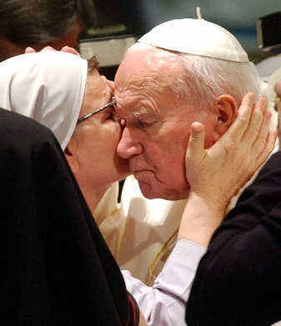 
Pope John Paul II is embraced by a nun during the weekly general audience Wednesday in the Paul VI Hall at the Vatican. 
 (Associated Press / The Spokesman-Review)