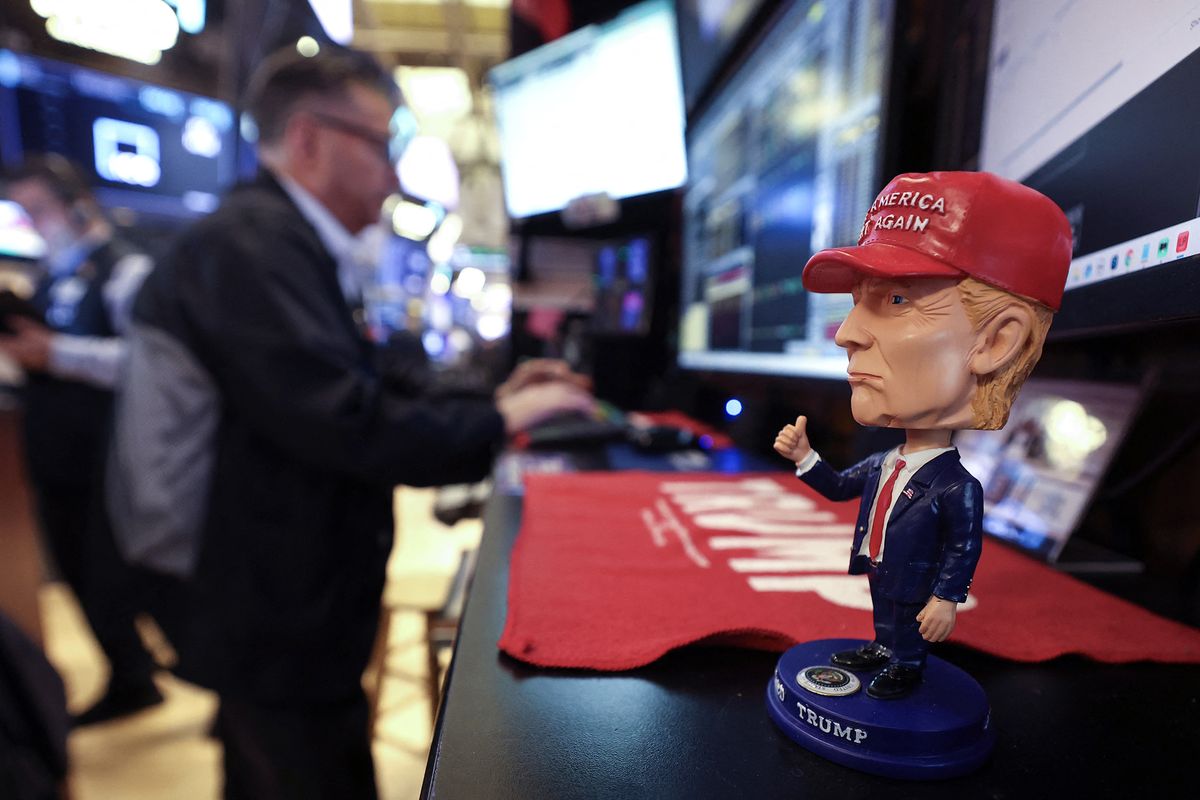 A bobblehead depicting President Donald Trump sits on a desk as traders works on the floor of the New York Stock Exchange at the opening bell on April 14 in New York City. (Timothy A. Clary/AFP)