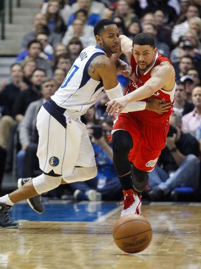 Dallas guard Devin Harris, left, shoves Clippers guard Austin Rivers as they scramble for a loose ball in Mavs’ 129-99 win. (Associated Press)