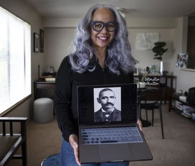 Maisha Barnett, of Seattle, holds a photo of her great-grandfather John Conna, who was enslaved in Texas as a young person, fought for the Union during the Civil War and was one of the first Black people to settle in Tacoma.  (Steve Ringman/Seattle Times)