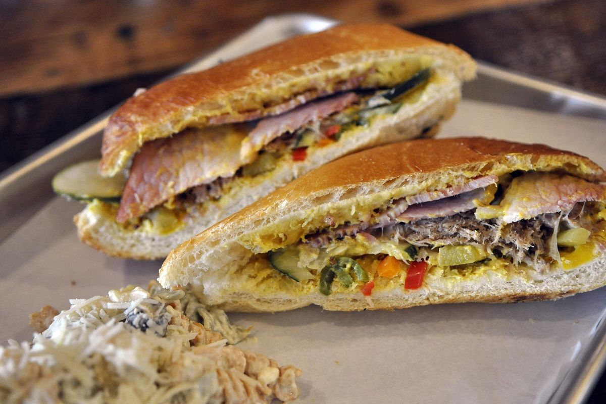 The menu at the new North Hill on Garland includes pizza, flat breads, Hot Hill Pockets and sandwiches, such as this Cubano with pulled pork, uncured ham, house mustard, baby Swiss, pickles and pickled peppers. (Adriana Janovich / The Spokesman-Review)