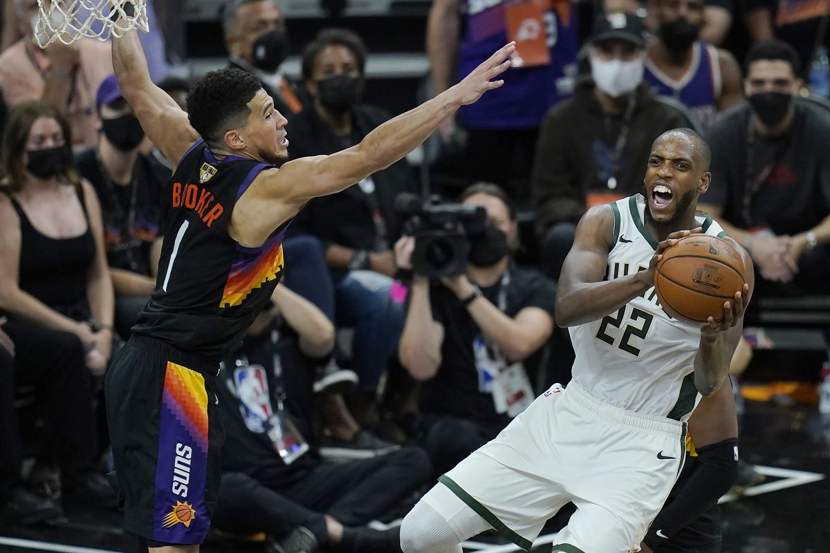 Milwaukee Bucks forward Khris Middleton (22) is defended by Phoenix Suns guard Devin Booker during the second half of Game 2 of basketball