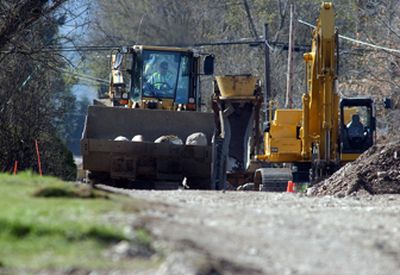 
Crews work on removing rocks and clearing a path to install sewer lines on Center Road in Spokane Valley. 
 (Liz Kishimoto / The Spokesman-Review)