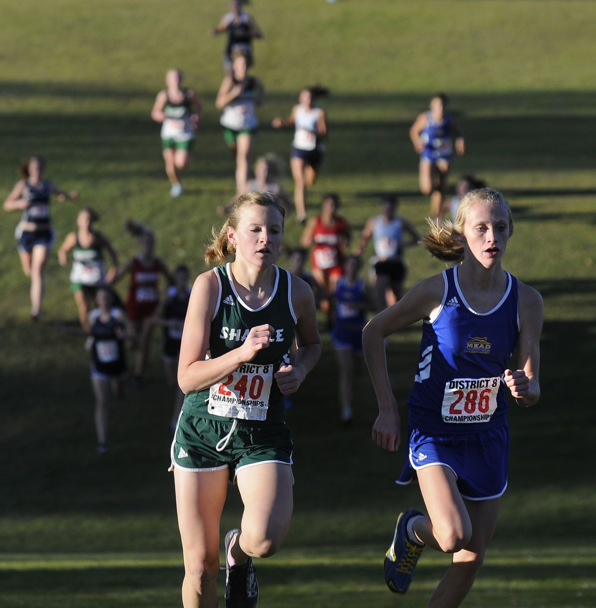 Mead’s Baylee Mires, right, battles with Shadle Park’s Andrea Nelson.  (Dan Pelle / The Spokesman-Review)