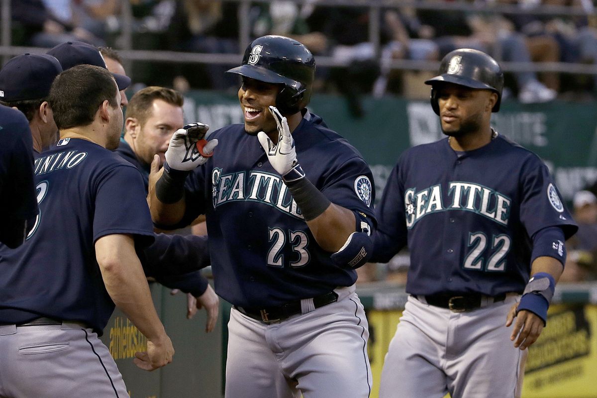 Seattle’s Nelson Cruz, center, is greeted by teammates after hitting a home run that also scored Robinson Cano, right. (Associated Press)