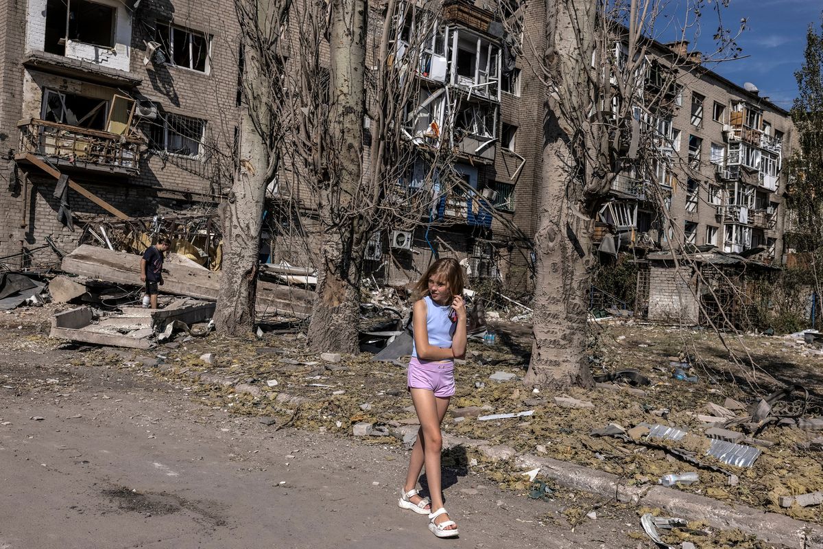 Liza Seridenko, 12, strolls outside the destroyed building block this month in the eastern city of Pokrovsk, Ukraine, where her mother worked as a cosmetician. MUST CREDIT: Photo for The Washington Post by Heidi Levine  (Heidi Levine/For The Washington Post)