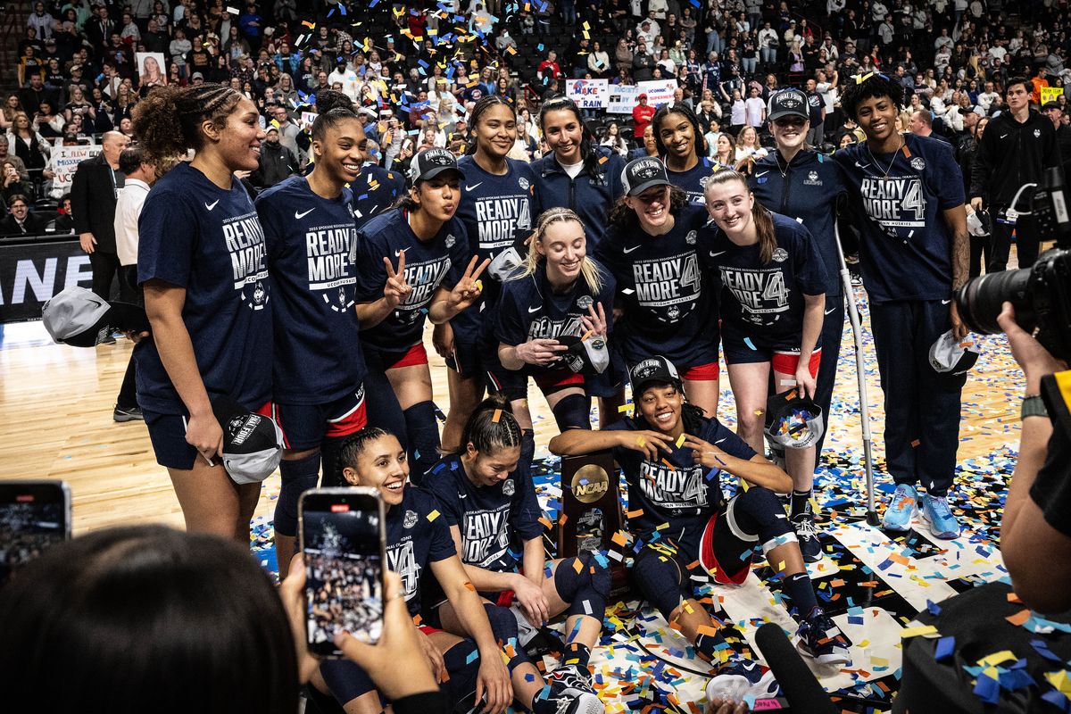 The UConn Huskies have their photo taken with the Elite 8 trophy after defeating USC 78-64 during a Spokane Regional 1 Elite 8 NCAA women’s basketball game, Monday, March 31, 2025, in the Spokane Arena. (COLIN MULVANY)