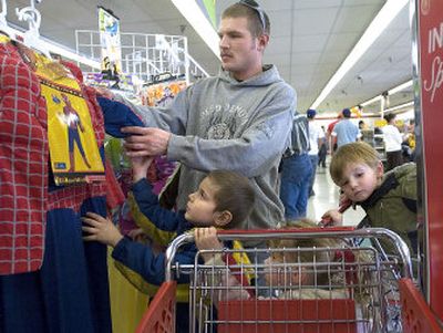 
Zach Miley and his children Logan, 5, Claire, 3, and Zach Jr., 2, look at Spiderman costumes at Value Village in Spokane on Saturday. 
 (Photos by JOE BARRENTINE / The Spokesman-Review)