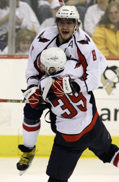 Alexander Ovechkin (8),  celebrates after David Steckel’s (39) OT goal.  (Associated Press / The Spokesman-Review)