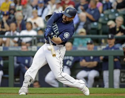 The Seattle Mariners’ Yonder Alonso doubles against the Baltimore Orioles in the first inning of a Aug. 14, 2017 game in Seattle. (Elaine Thompson / Associated Press)