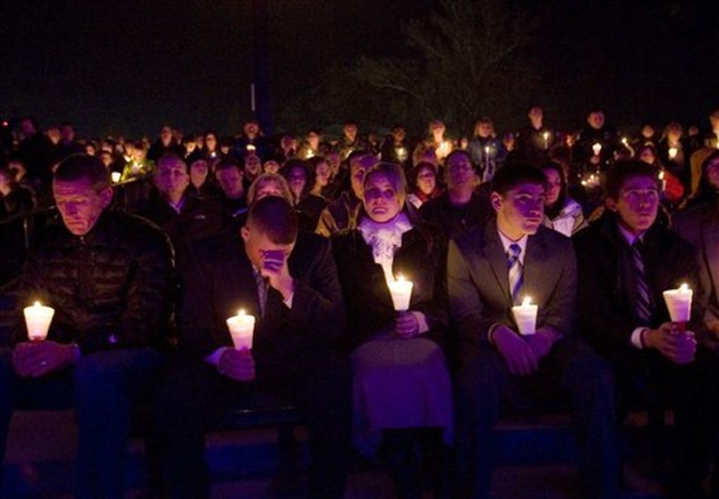 Relatives of Jared Francom from second left, brother Travis Francom, Travis' wife Jessica Francom, and brothers Ben Francom and Gunner Francom attend a candle light vigil for law enforcement officers shot the night before, Thursday, Jan. 5, 2012, in Ogden, Utah. Six area law enforcement officers were shot Wednesday night while serving a search warrant. Jared Francom died from his wounds.(AP Photo/The Salt Lake Tribune, Kim Raff)  ((AP Photo/The Salt Lake Tribune, Kim Raff) )