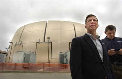 
 James Crites, left, executive vice president of Dallas/Fort Worth Airport operations, and Ken Capps stand in front of a 6-million- gallon thermal storage tank that has significantly cut energy costs at the airport. 
 (Associated Press / The Spokesman-Review)
