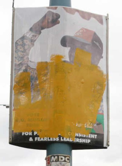 
A defaced election poster with a portrait of President Robert Mugabe hangs on a telegraph pole in Harare on Wednesday. Associated Press
 (Associated Press / The Spokesman-Review)