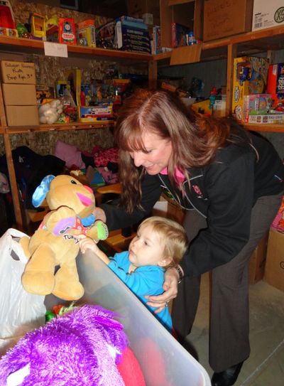 Sheila Geraghty, business administrator at Salvation Army, helps Nevaeh Sevier check out the Christmas Angel gifts last December.