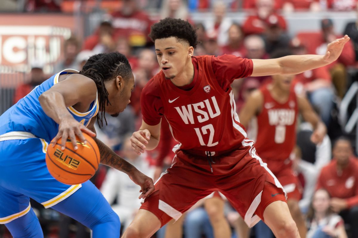 iWashington State guard Isaiah Watts, right, puts pressure on UCLA guard Sebastian Mack n the first half on Saturday, March 2, 2024, at Beasley Coliseum in Pullman.  (Geoff Crimmins/For The Spokesman-Review)