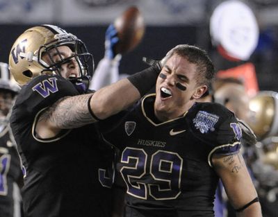 Washington’s Nate Fellner, right, celebrates his first-half interception against Nebraska with teammate Cort Dennison.   (Associated Press)
