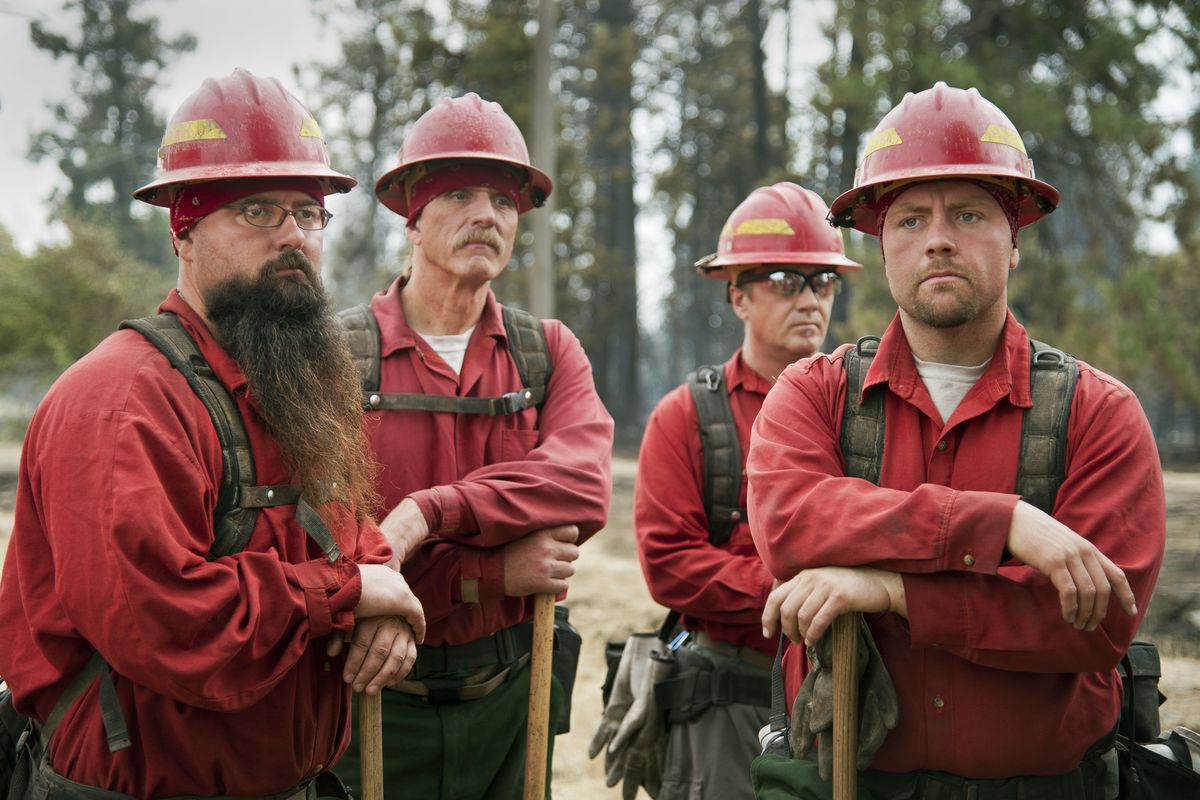 Inmates from Airway Heights Corrections Center, from left, Johnathen Harmon, John Zuvela, David Doud and Braeson Haskell await mop-up duty Friday near Geiger Boulevard. The firefighting team is known as Heights 43. (Dan Pelle)