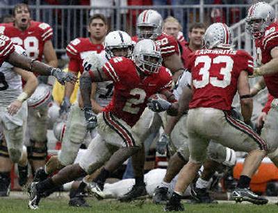 
Buckeye cornerback Malcolm Jenkins (2) runs for the end zone after intercepting a pass Saturday. 
 (Associated Press / The Spokesman-Review)