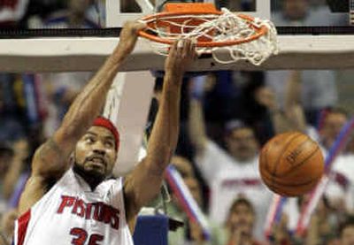 Detroit's Rasheed Wallace grabs the rim after dunking during Tuesday's Game 5 of the Eastern Conference semifinals.
(Associated Press / The Spokesman-Review)