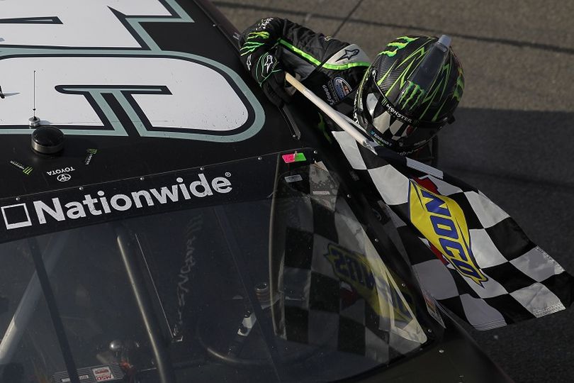 Kyle Busch, driver of the #54 Monster Energy Toyota, grabs the checkered flag after winning the NASCAR Nationwide Series Royal Purple 300 at Auto Club Speedway on March 23, 2013 in Fontana, California. (Photo by Todd Warshaw/NASCAR via Getty Images) (Todd Warshaw / Nascar)