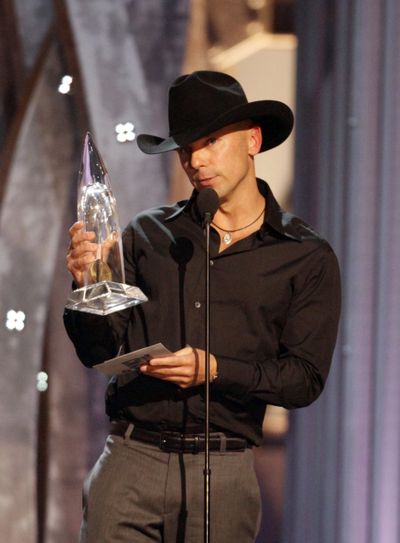 Kenny Chesney accepts the CMA Entertainer of the Year award  on Wednesday.   (Associated Press / The Spokesman-Review)