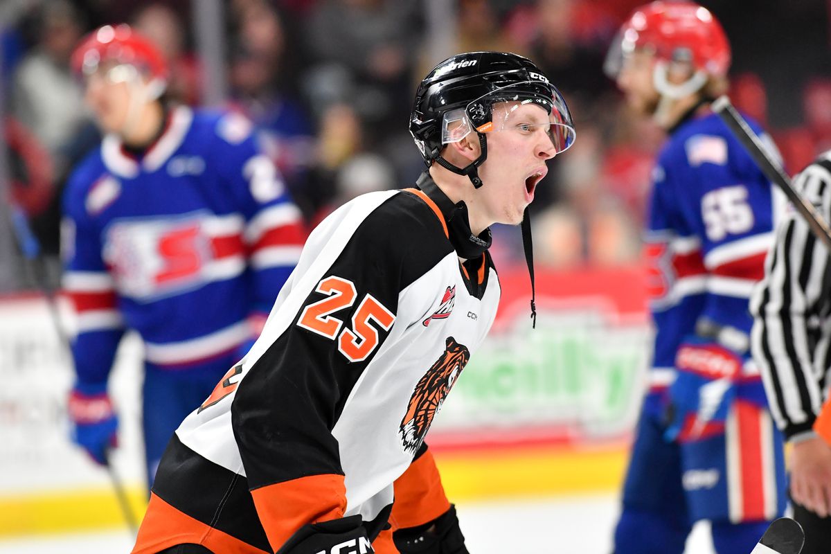 Medicine Hat goaltender Harrison Meneghin hoists the Ed Chynoweth Cup after the Tigers won the WHL Championship against Spokane on Friday at the Arena. (Tyler Tjomsland/The Spokesman-Review)