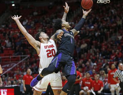 Washington guard David Crisp  shoots as Utah forward Timmy Allen  defends during the first half  Thursday  in Salt Lake City. (Rick Bowmer / AP)