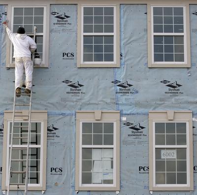 Yuri Kyryk, 25, works on new condominiums Friday in Pepper Pike, Ohio. The construction sector added jobs in April. (Associated Press)