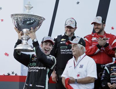In this Sept. 18, 2016, file photo, Simon Pagenaud, of France, holds up the Astor Cup after winning the IndyCar auto race and IndyCar championship as team owner Roger Penske, lower right, looks on in Sonoma, Calif. Pagenaud leads a dominant Team Penske squad into IndyCar’s season-opening race on Sunday, and the Frenchman has his eye on a second consecutive series championship. (Eric Risberg / Associated Press)