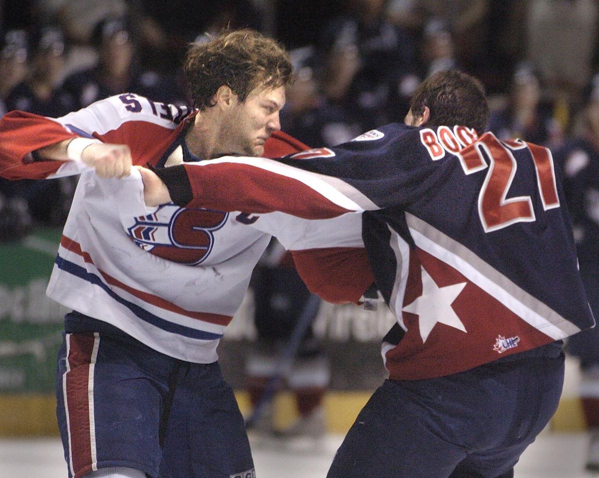 Spokane Chief Jevon Desutels and Tri-cities Aaron Boogard fight during the first period of their match in the Spokane Arena, Jan. 22, 2005. (SR)