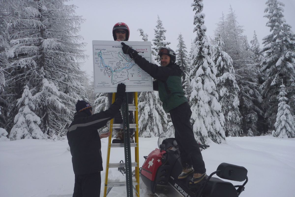 Pictured above from left, Drew Schlieder, Sam Schlieder and George Momany from Spokane Nordic Ski Association were taking down old signs on the north half of the trail system on Dec. 16, 2012, and replacing them with signs that included  more than 12 kilometers of new groom trails added this season.  The total groomed trails system at Mount Spokane Cross-Country Ski Park is more than 42 kilometers. (Rich Landers)