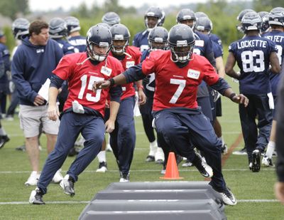 Seahawks quarterback Tarvaris Jackson (7) leads quarterback Matt Flynn (15) and others through an agility drill on Thursday. (Associated Press)