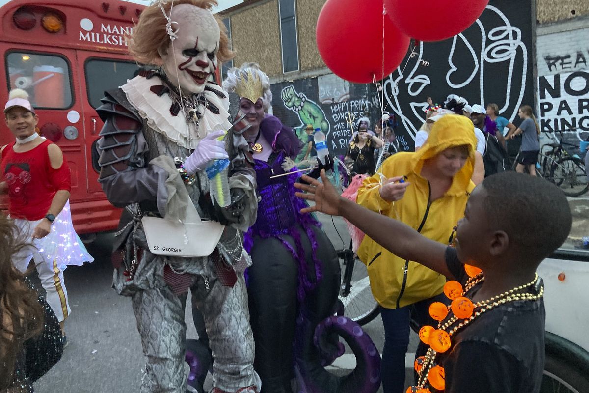 A costumed man greets a young boy at the Krewe of Boo parade on Saturday in New Orleans.  (Rebecca Santana)