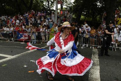 
A woman dances down Fifth Avenue at the Puerto Rican Day Parade in New York on Sunday. Thousands celebrate their culture each year. 
 (Associated Press / The Spokesman-Review)