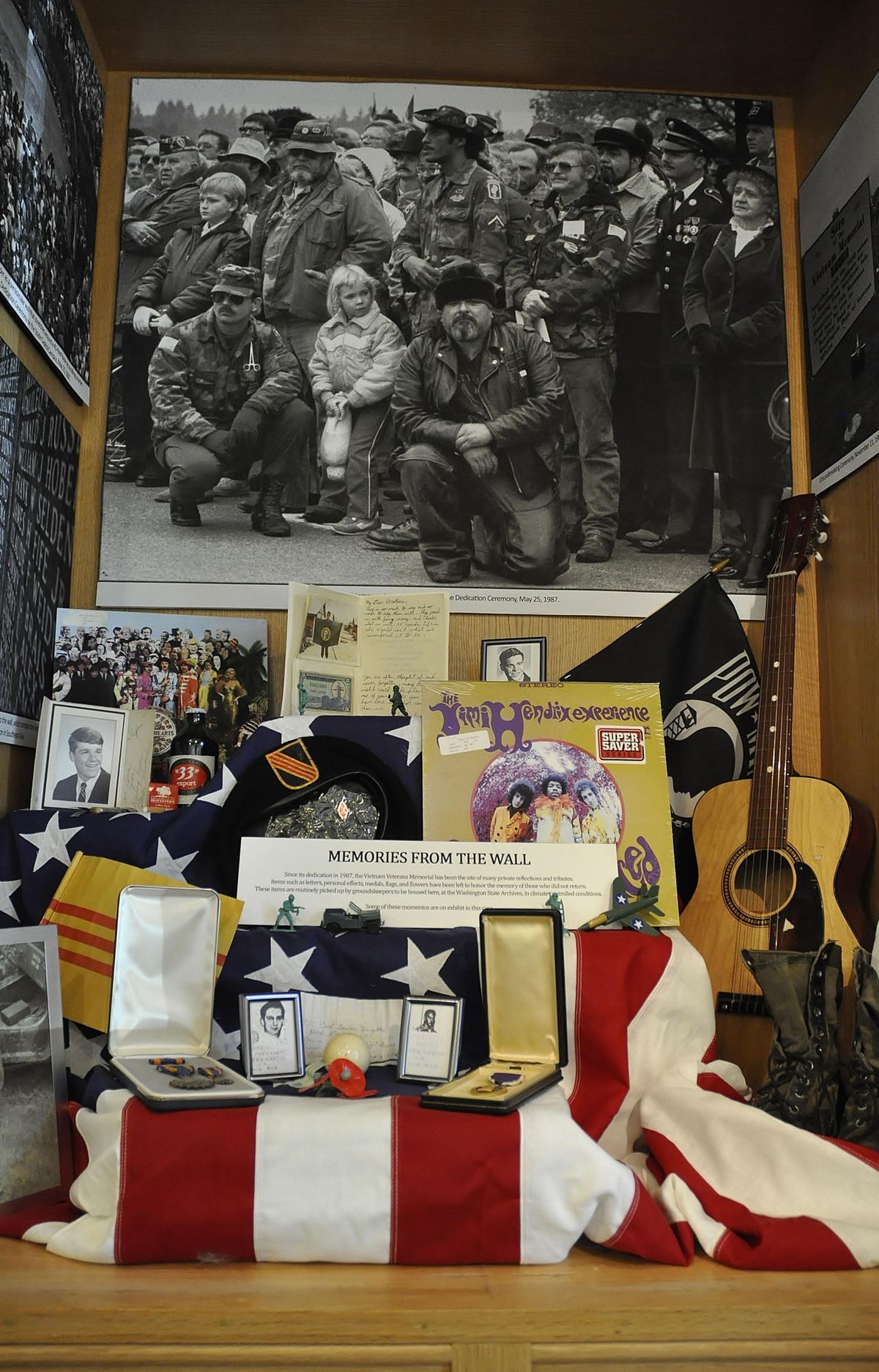 The display case in the lobby of the State Archives Building has a rotating collection of items left at the Vietnam Memorial Monument. (Jim Camden / The Spokesman-Review)
