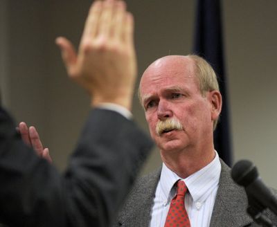 After he served as police chief and city administrator of Post Falls, the late Cliff Hayes was elected Kootenai County clerk. Here, he is shown being sworn in as county clerk on Jan. 10, 2011. As a police chief, Hayes once suggested that cats be licensed. (SR file photo)