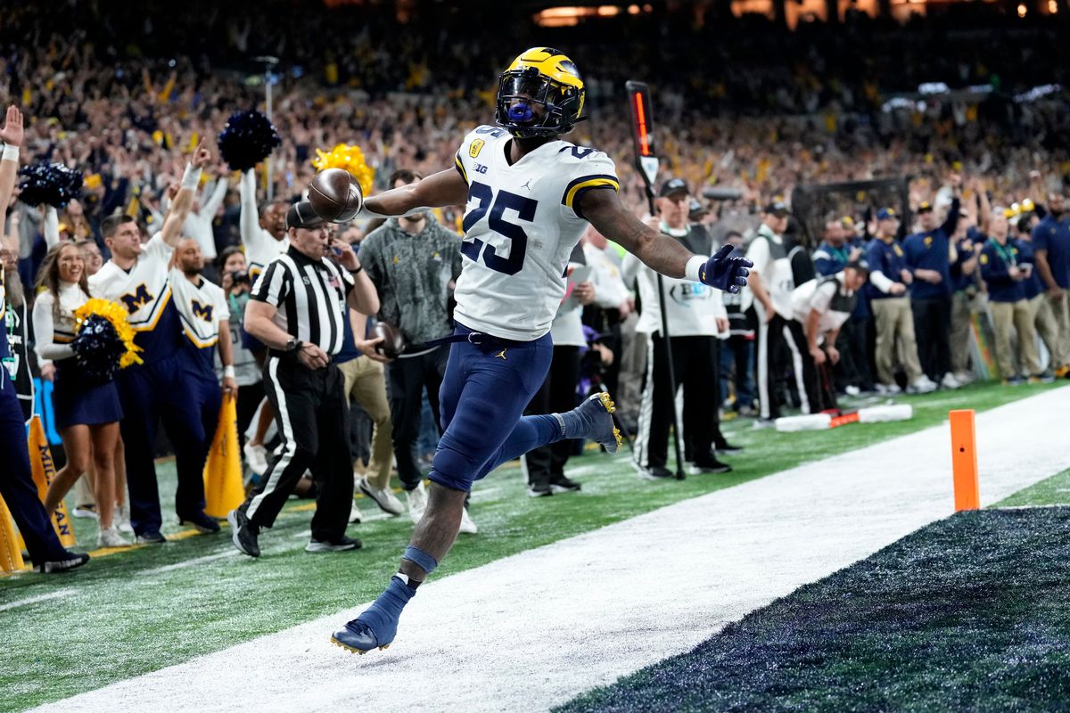 Michigan running back Hassan Haskins (25) celebrates after scoring on a 4-yard touchdown run during the second half of the Big Ten championship NCAA college football game against Iowa, Saturday, Dec. 4, 2021, in Indianapolis.  (AJ Mast)