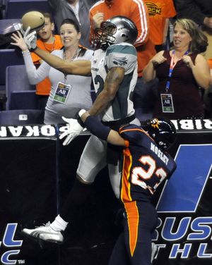 Bossier-Shreveport's Randy Hymes (12) makes a one-handed catch to score on the Spokane Shock's Roderick Mosley in the first quarter April 17, 2010, in the Spokane Arena. (Dan Pelle / The Spokesman-Review)